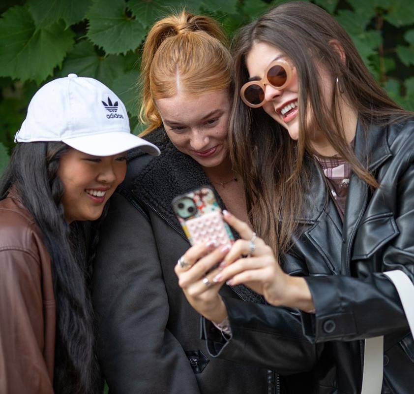 girls looking at cellphone